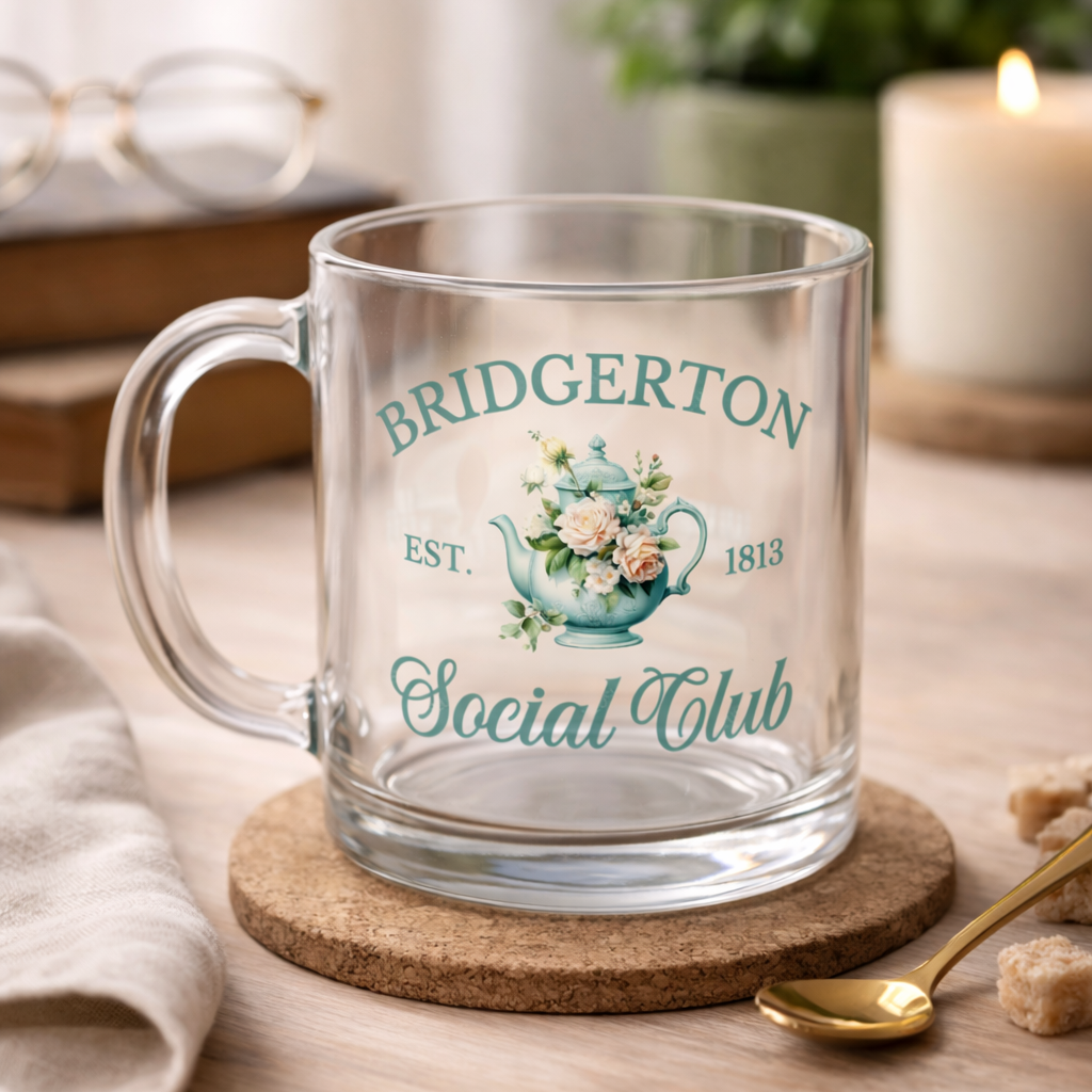 Clear glass mug with 'Bridgerton Social Club' design on a wooden coaster.