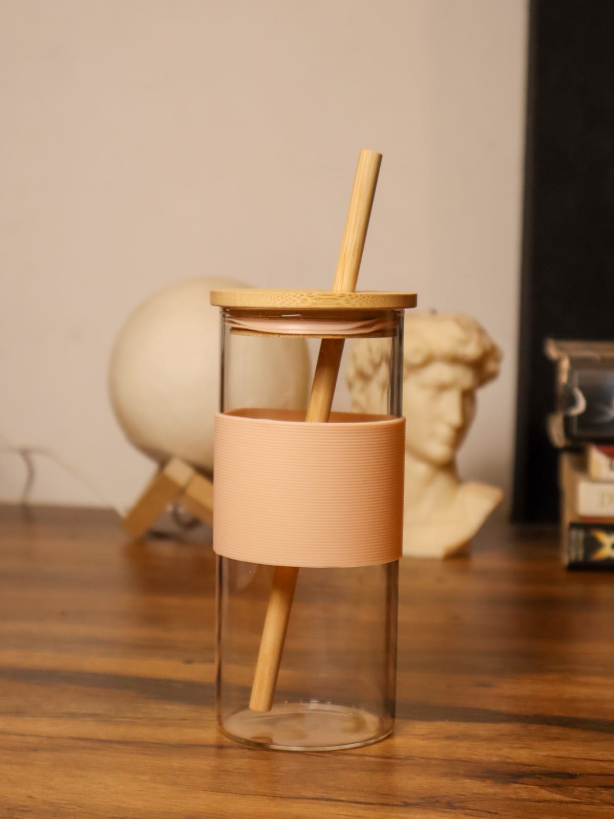 Glass tumbler with bamboo straw and silicone sleeve