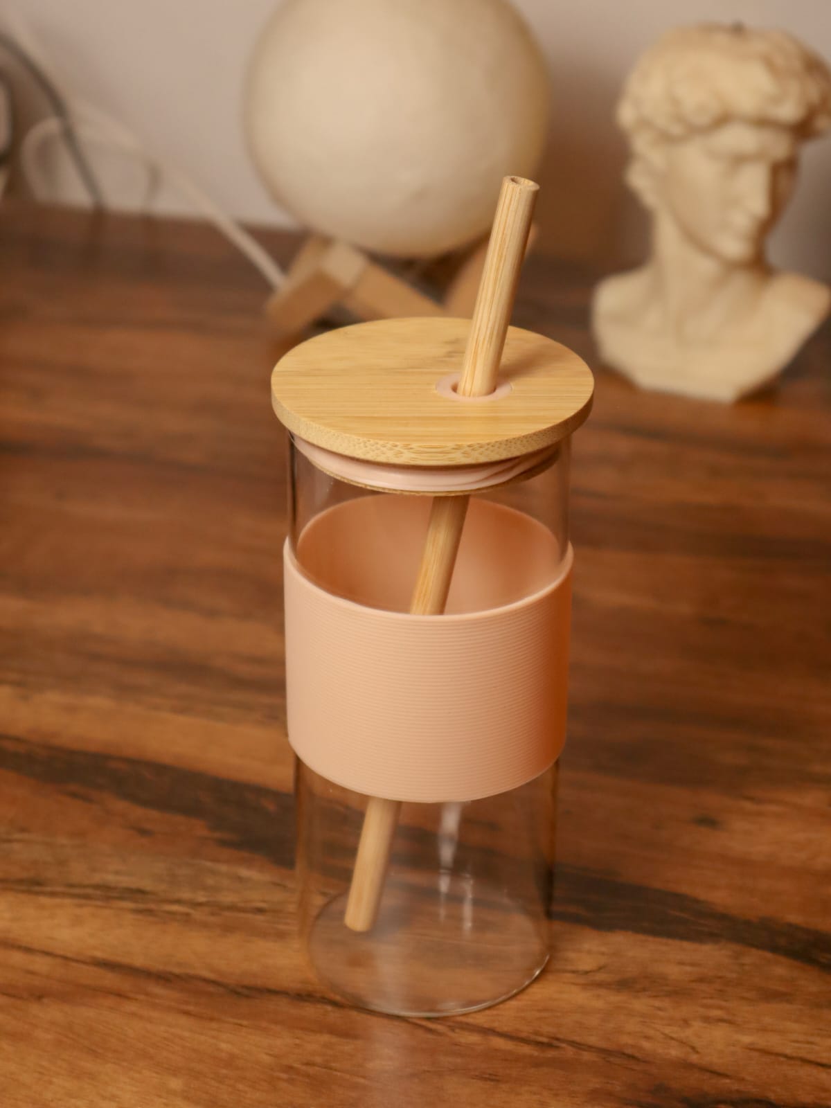 Glass tumbler with bamboo straw and silicone sleeve