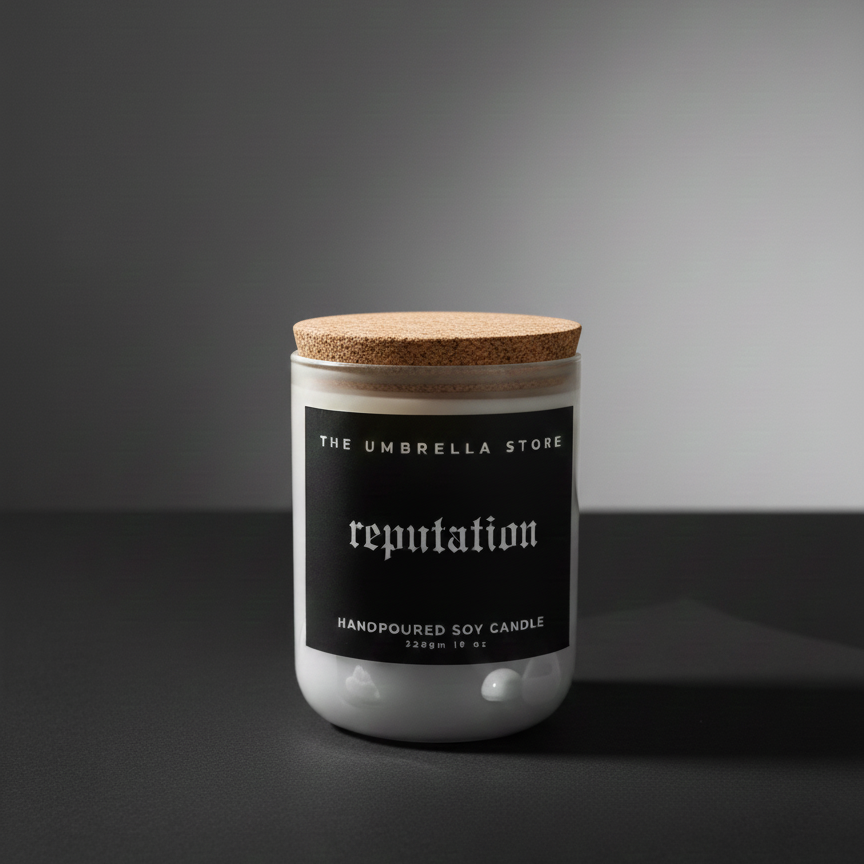 Candle jar with cork lid labeled 'reputation' from 'The Umbrella Store' on a dark background