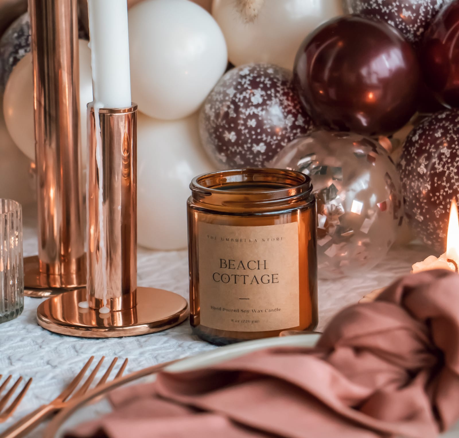 Scented candle on a dinner table setting